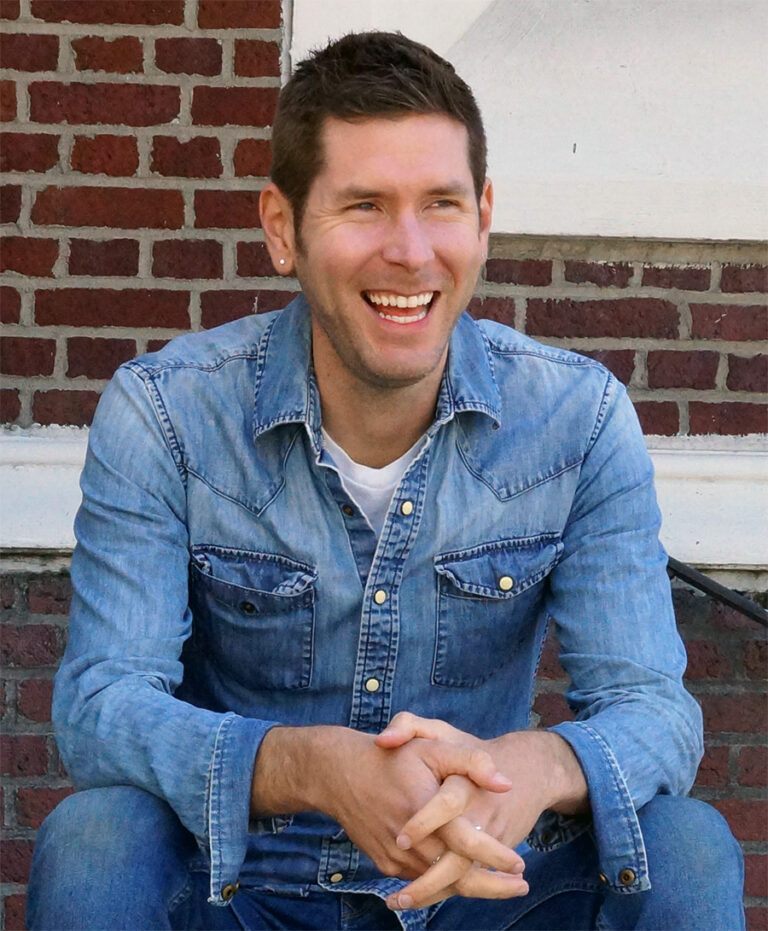 Jeremy Laurin Smiling on a set of Stairs for JoyfulJeremy.com